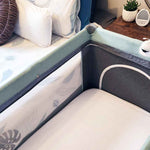 Fitted white cot sheet in a cot