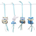 A set of four handcrafted felt dingle dangle toys in woodland animal shapes in shades of blue: a rabbit, an owl, a fox, and a raccoon. Made from soft felt with ribbons, designed for infant sensory development.