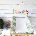 A set of four handcrafted dingle dangle toys in a multi-coloured safari theme: A lion, giraffe, elephant, and monkey. Made from soft felt with ribbons, designed for infant sensory development.