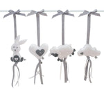 A set of four handcrafted dingle dangle toys in grey and white them: a bunny, heart, lamb, and cloud. Made from soft felt with ribbons, designed for infant sensory development.