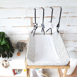 A set of four handcrafted dingle dangle toys in black and white them: a panda, feather, star, and cloud. Made from soft felt with ribbons, designed for infant sensory development.