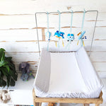 A set of four handcrafted dingle dangle toys in transport theme in blues: a train, hot air balloon, volksie, and plane. Made from soft felt with ribbons, designed for infant sensory development.