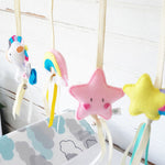 A set of four handcrafted dingle dangle toys in fantasy unicorn theme in bright colours: a unicorn, shooting star, star, and rainbow. Made from soft felt with ribbons, designed for infant sensory development.