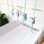 A set of four handcrafted dingle dangle toys in woodland animal shapes in shades of blue: a rabbit, an owl, a bear, and a deer. Made from soft felt with ribbons, designed for infant sensory development.