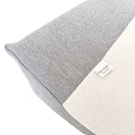 A close-up of a gray textured baby change mat cover with white towelling centre on a pure white background.