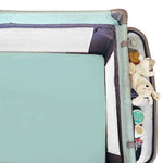 A green cot sheet in a cot