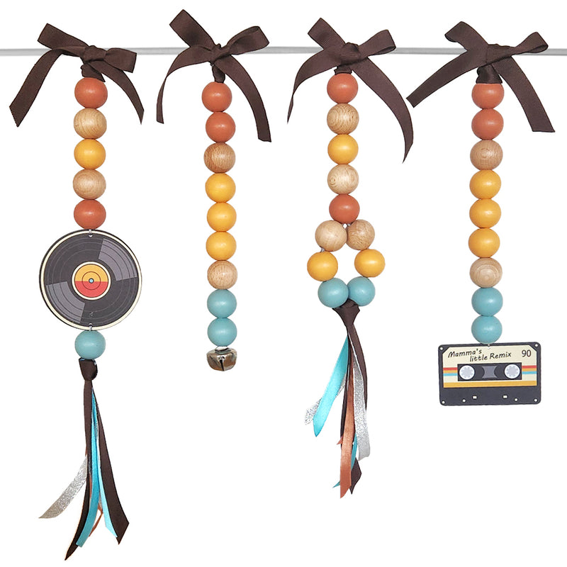 Decorative beads with ribbons and a tape and record player on a white background