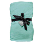 A green fitted cot sheet with a black ribbon bow on top, displayed against a white background.