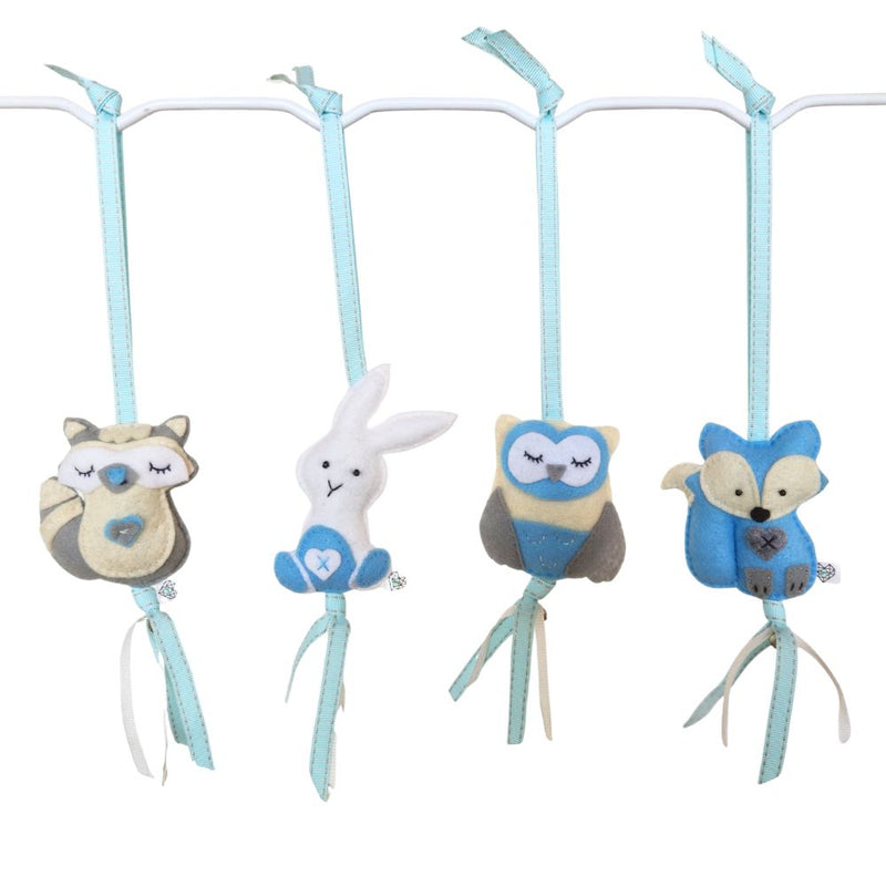 A set of four handcrafted felt dingle dangle toys in woodland animal shapes in shades of blue: a rabbit, an owl, a fox, and a raccoon. Made from soft felt with ribbons, designed for infant sensory development.