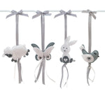 A set of four handcrafted dingle dangle toys in a meadow animal theme in grey and whit: a bunny, bird, lamb, and butterfly. Made from soft felt with ribbons, designed for infant sensory development.