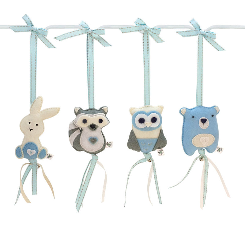 A set of four handcrafted dingle dangle toys in woodland animal shapes in shades of blue: a rabbit, an owl, a bear, and a deer. Made from soft felt with ribbons, designed for infant sensory development.