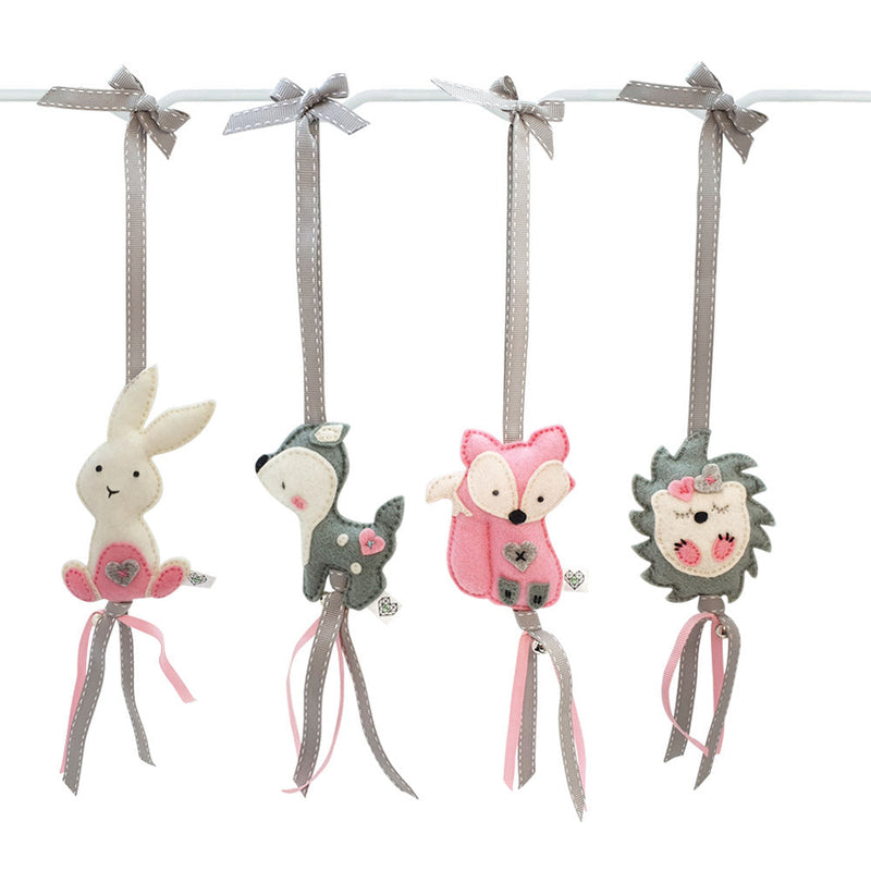 A set of four handcrafted dingle dangle toys in woodland animal shapes, made from soft felt with ribbons, designed for infant sensory development.